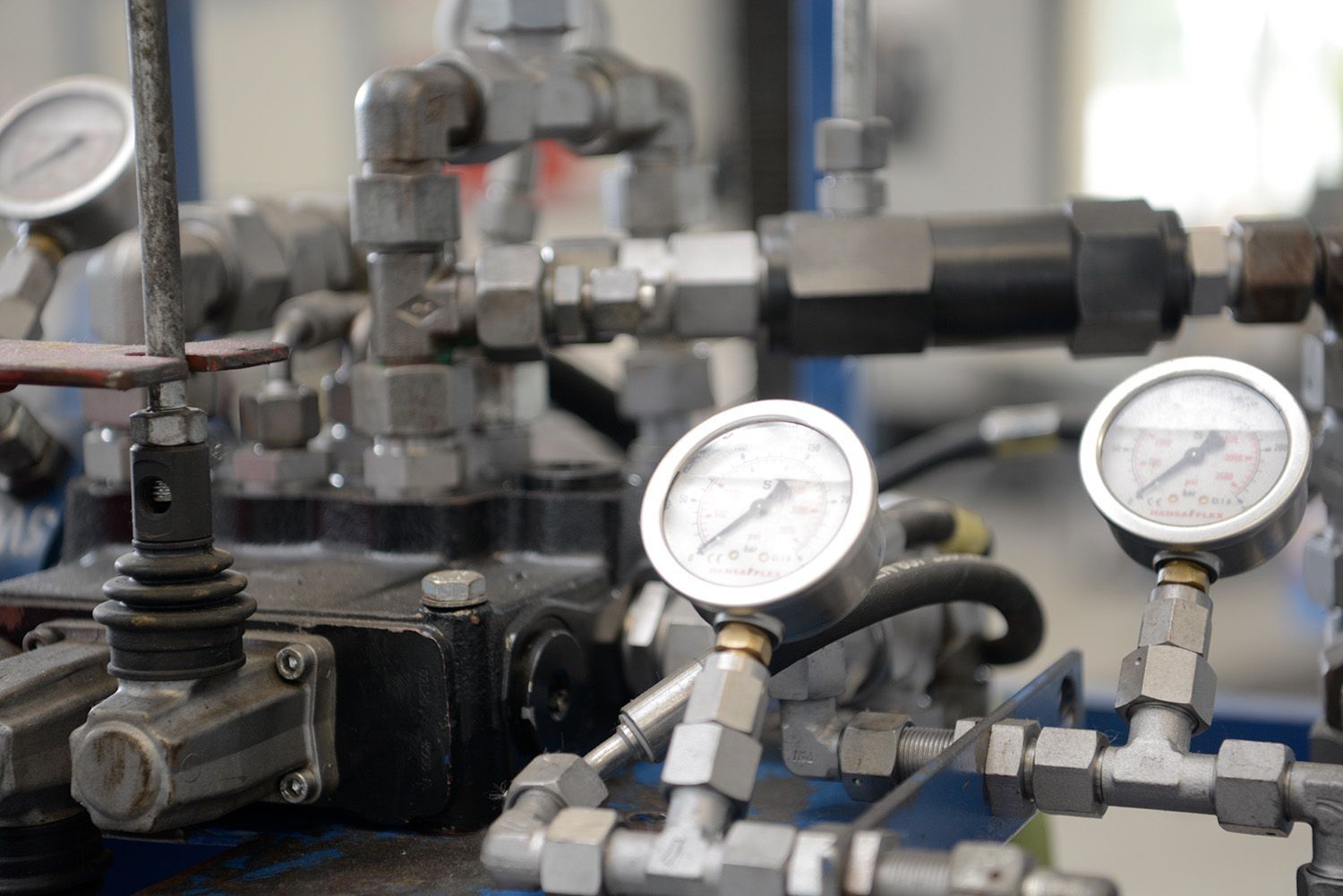 Pressure gauges and valves on a machine used to monitor and control pressure